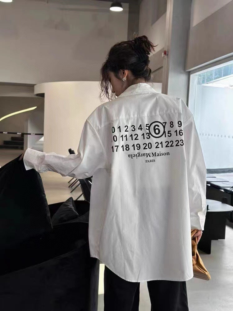 White button-up shirt with back graphic, worn by a person