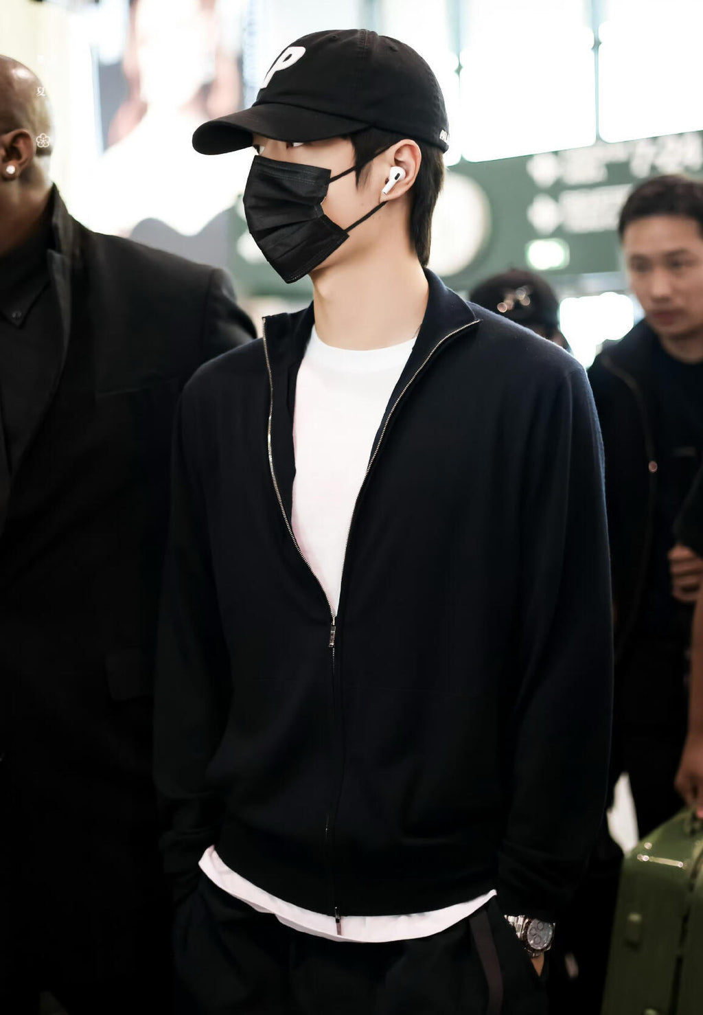 Black zip-front knit jacket worn with stand collar and long sleeves
