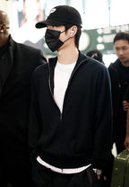 Black zip-front knit jacket worn with stand collar and long sleeves