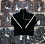 Black long-sleeve quarter-zip pullover with V-shaped white trim at the chest