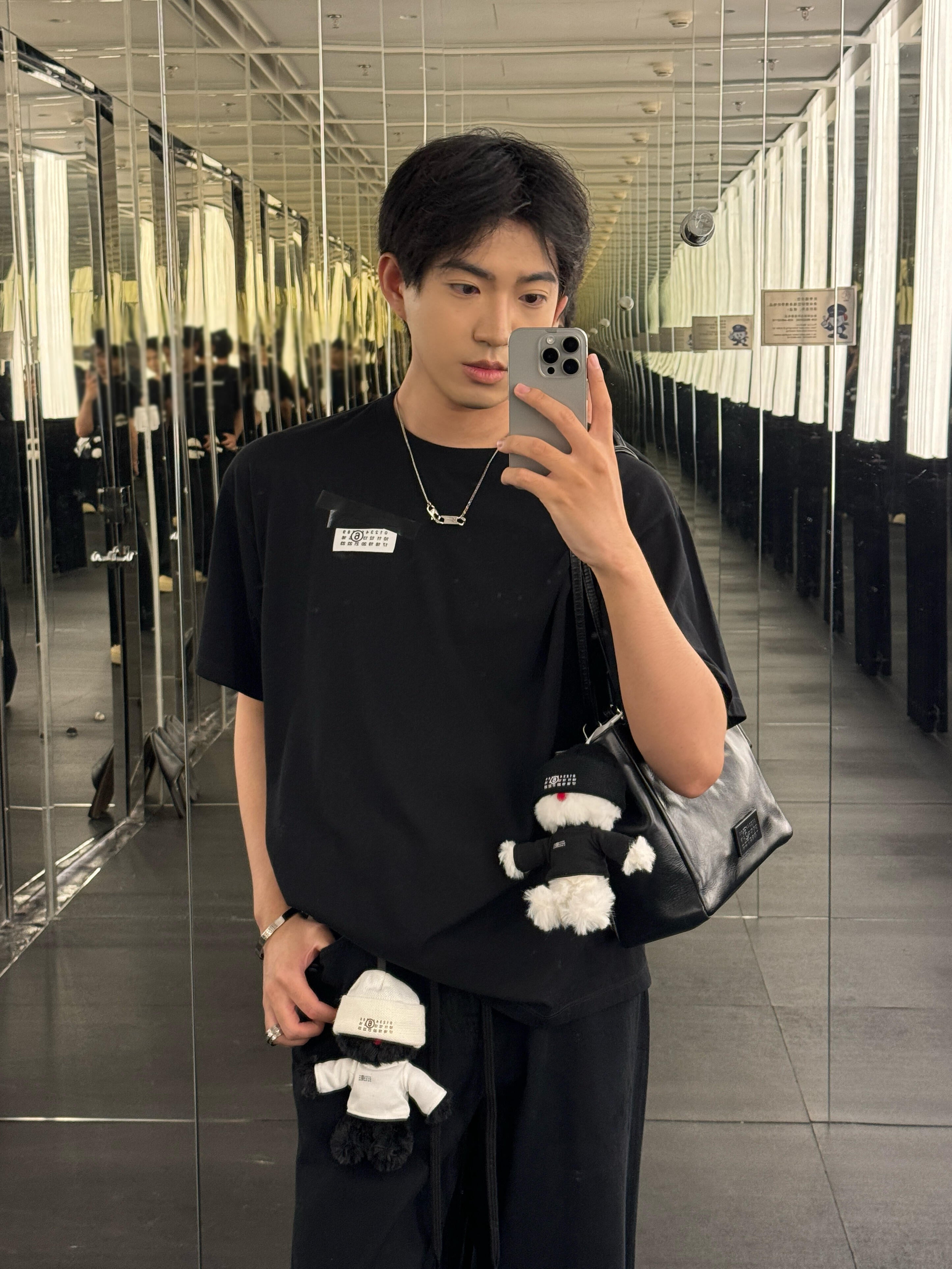 Black crew-neck T-shirt worn by model, short sleeves
