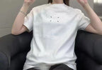 White crewneck T-shirt with small dash graphic on the upper back