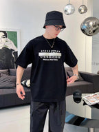 Black crew-neck T-shirt with Maison Margiela graphic numbers, worn by model