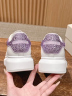 White sneakers with purple glitter heel tab and cushioned heel collar