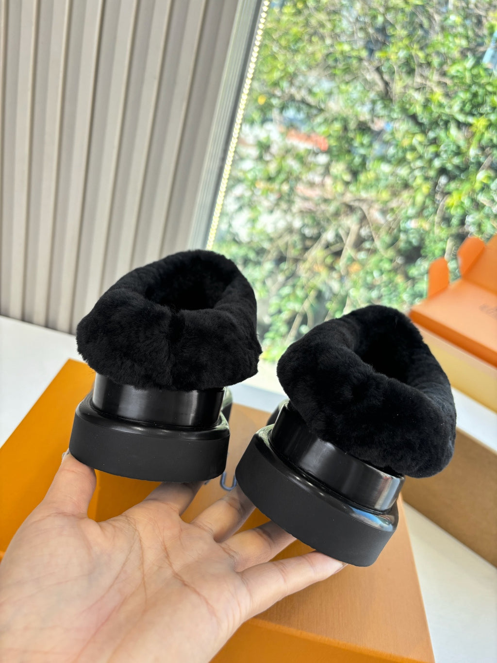 Louis Vuitton unisex black velvet loafers shown from heel with fur cuff and rubber sole