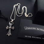Silver cross pendant necklace with linked chain and cord closure loop