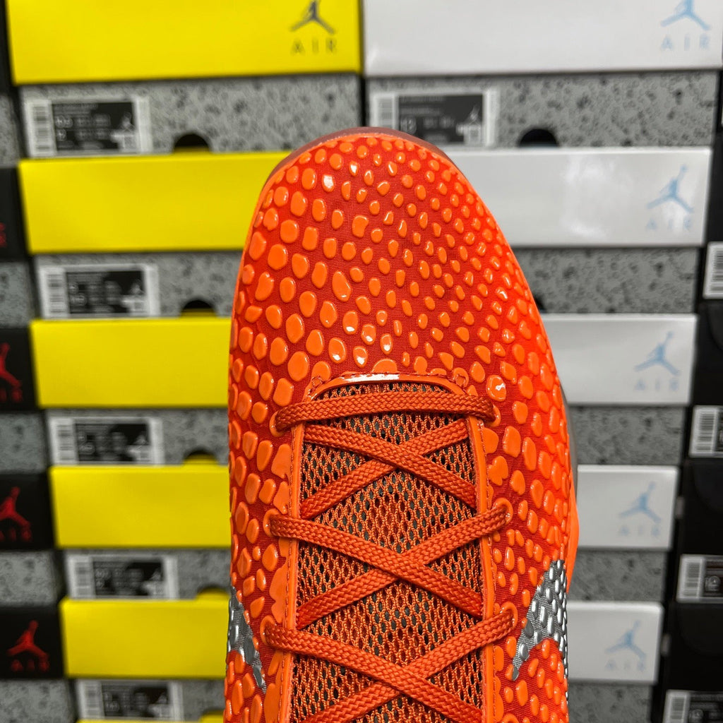 Orange sneaker toe and lace area with mesh-like textured pattern