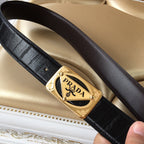 Black leather belt with gold Prada buckle, shown at diagonal angle
