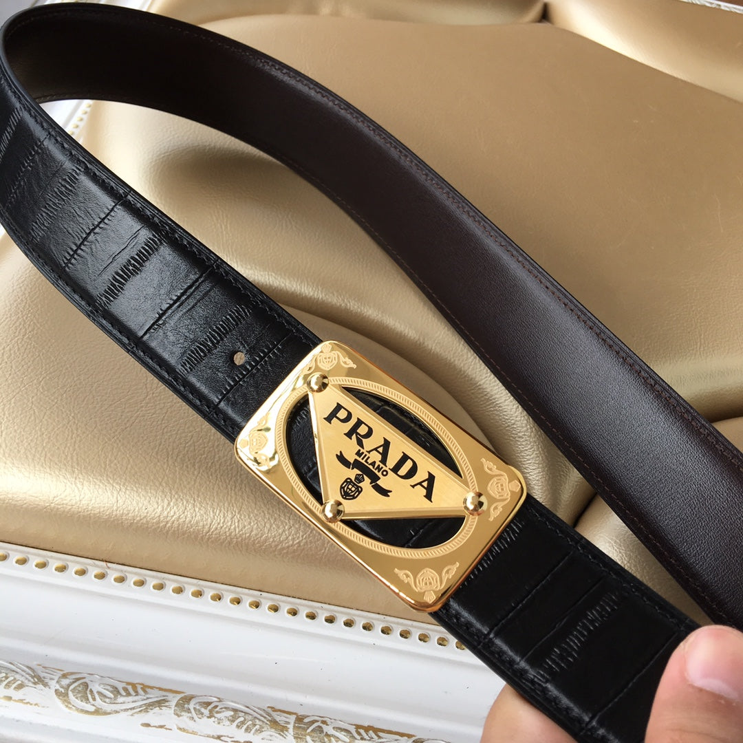 Black leather belt with gold Prada buckle, shown at diagonal angle