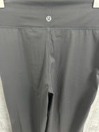 Dark gray pants front with small logo and central seam