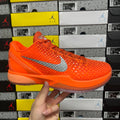 Orange athletic sneaker with gray swoosh and lace-up upper