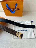 Louis Vuitton monogram belt with dark strap and gold-tone LV buckle, laid flat