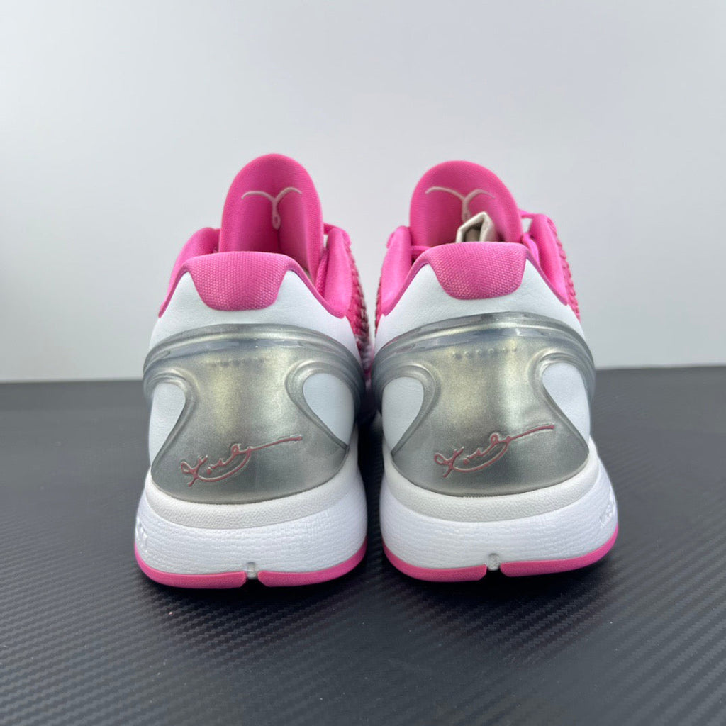 Pink heel and rear view of low-top sneakers with white midsole and pull tab