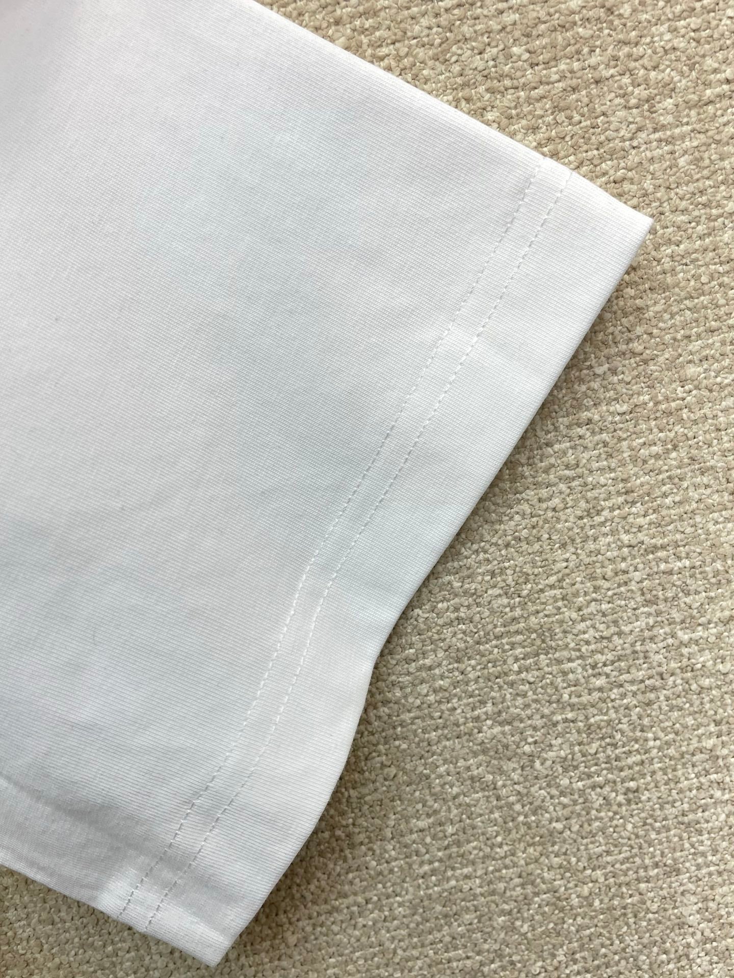 White T-shirt sleeve with stitched hem seam