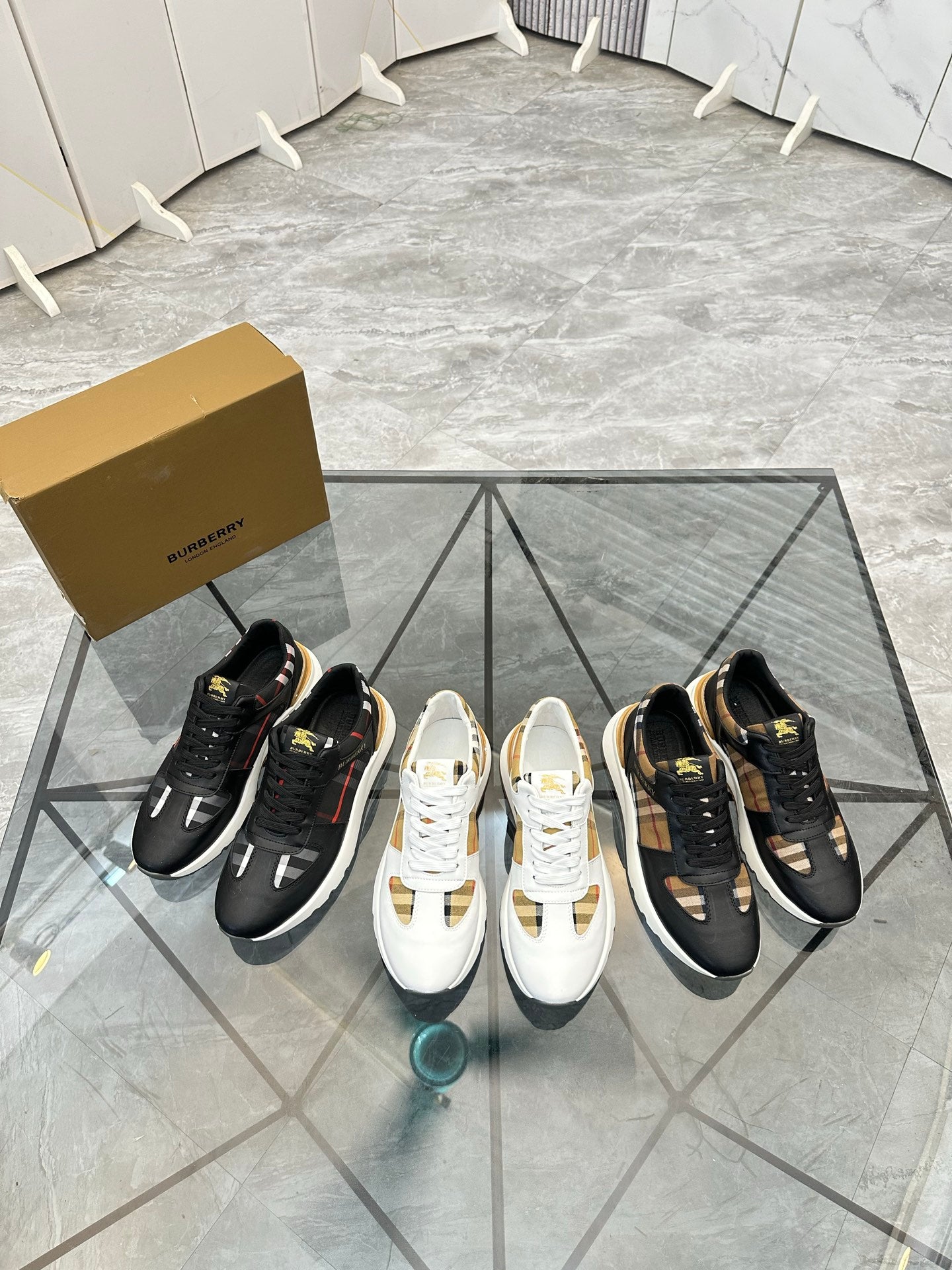 Set of Burberry sneakers: white, black, and white pair with check panel accents