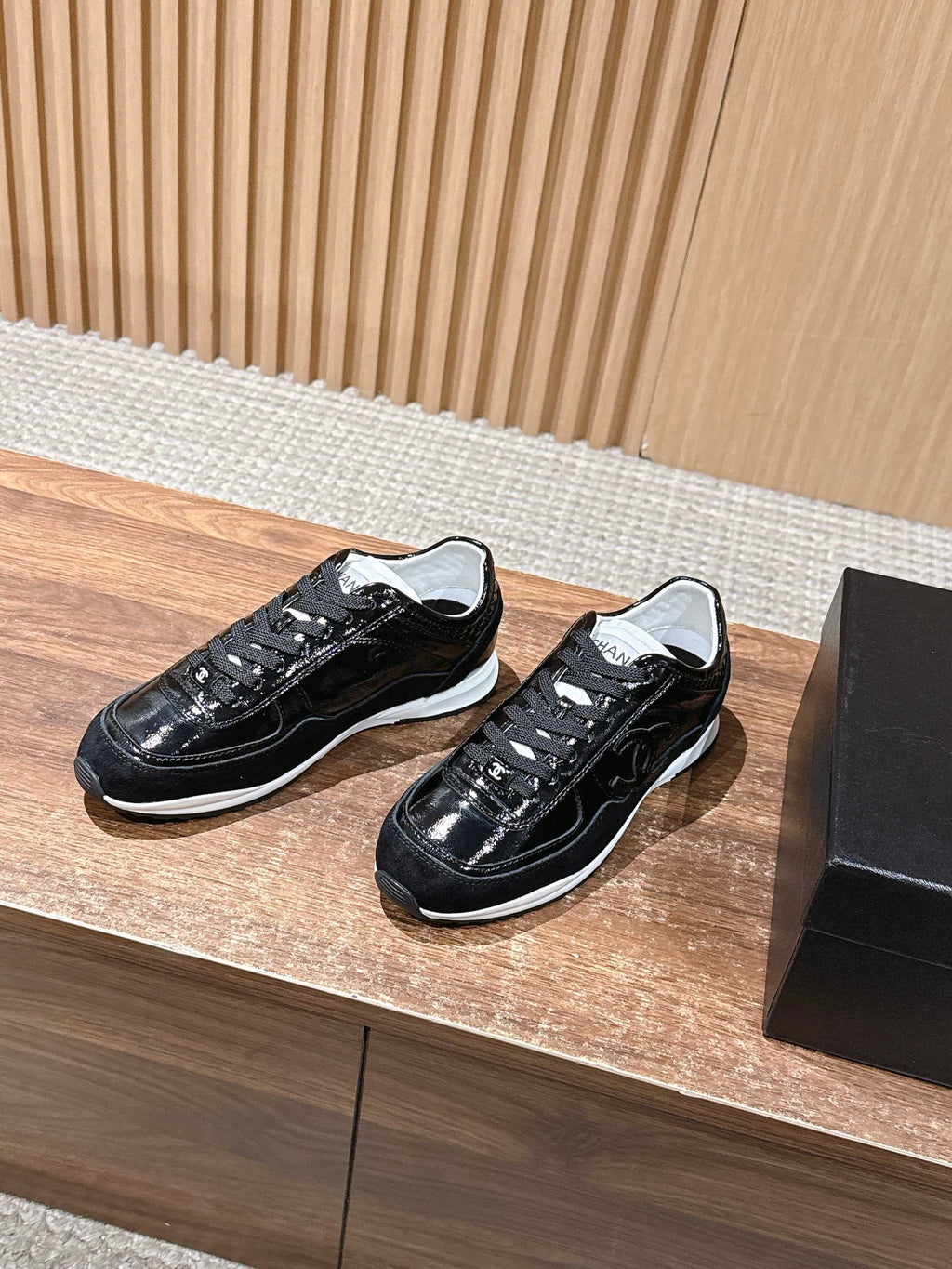 Black lace-up sneakers with white sole and contrasting laces, Chanel