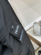 Black jacket fabric with Prada clothing tag and size label