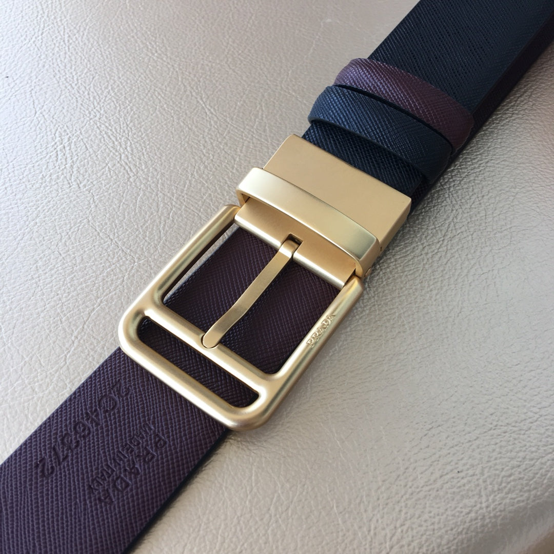 Leather belt buckle detail with gold-tone frame on dark blue and burgundy strap