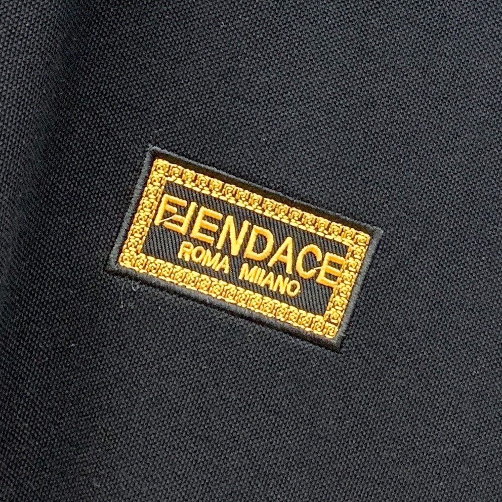 Black polo shirt label reading FENDACE Foma Milano