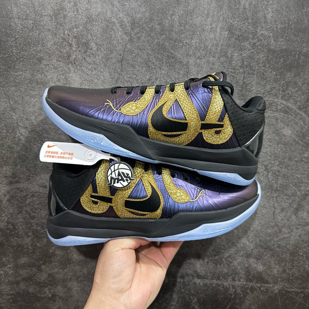 Basketball sneaker in dark purple with gold logo, black laces, light blue sole