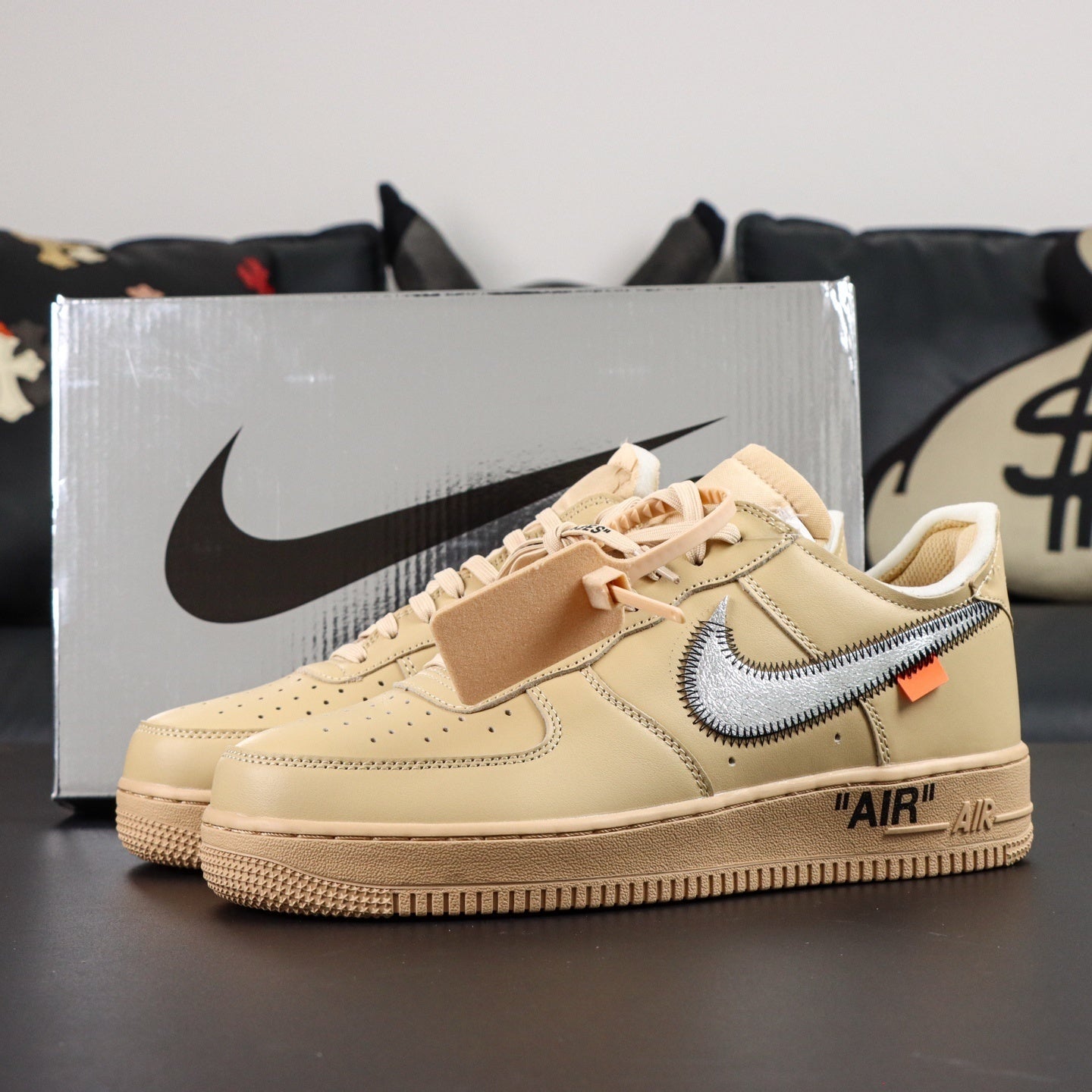 Cream low-top sneakers with blue Nike swoosh, lace-up front, and box in background