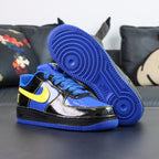 Nike Air Force 1 low-top sneakers, blue and black with yellow Swoosh; side profile and outsole.