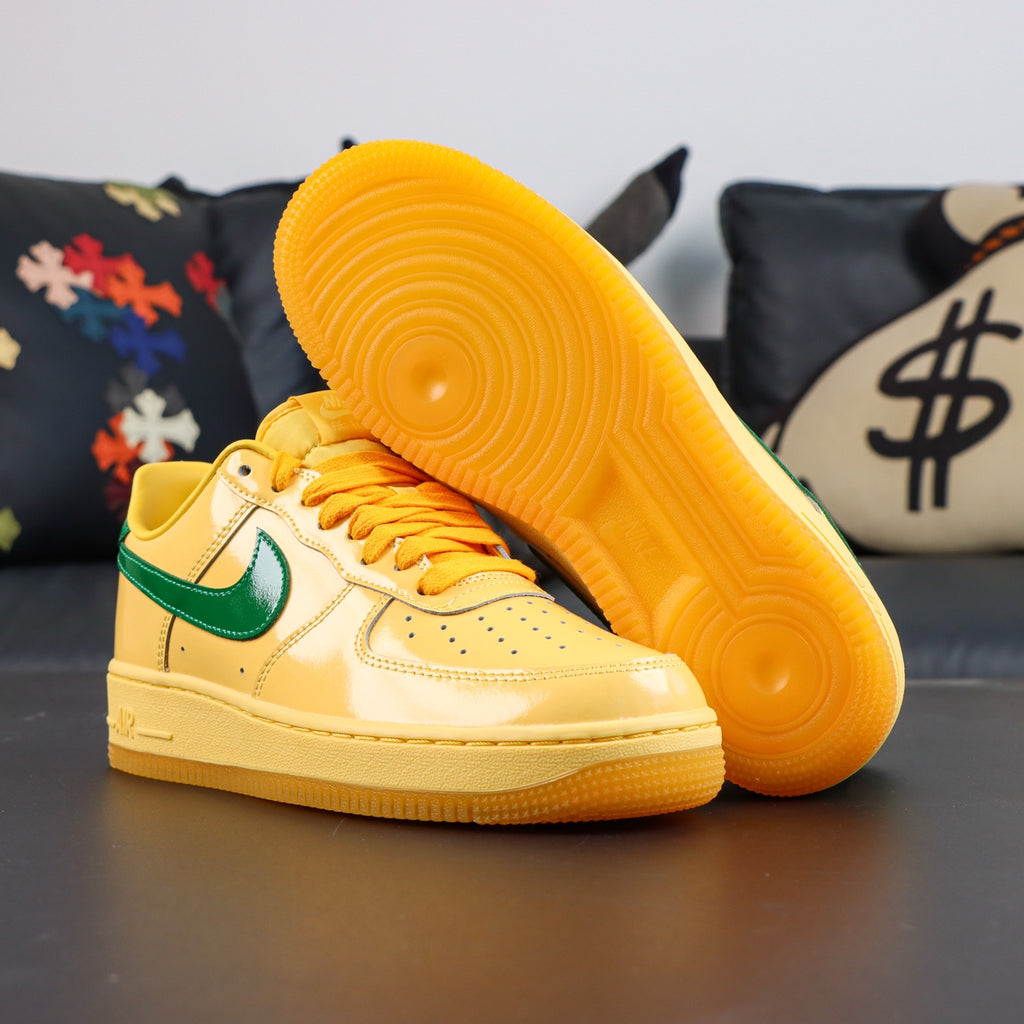 Nike Air Force 1 sneakers, yellow upper with green swoosh and orange gum outsole