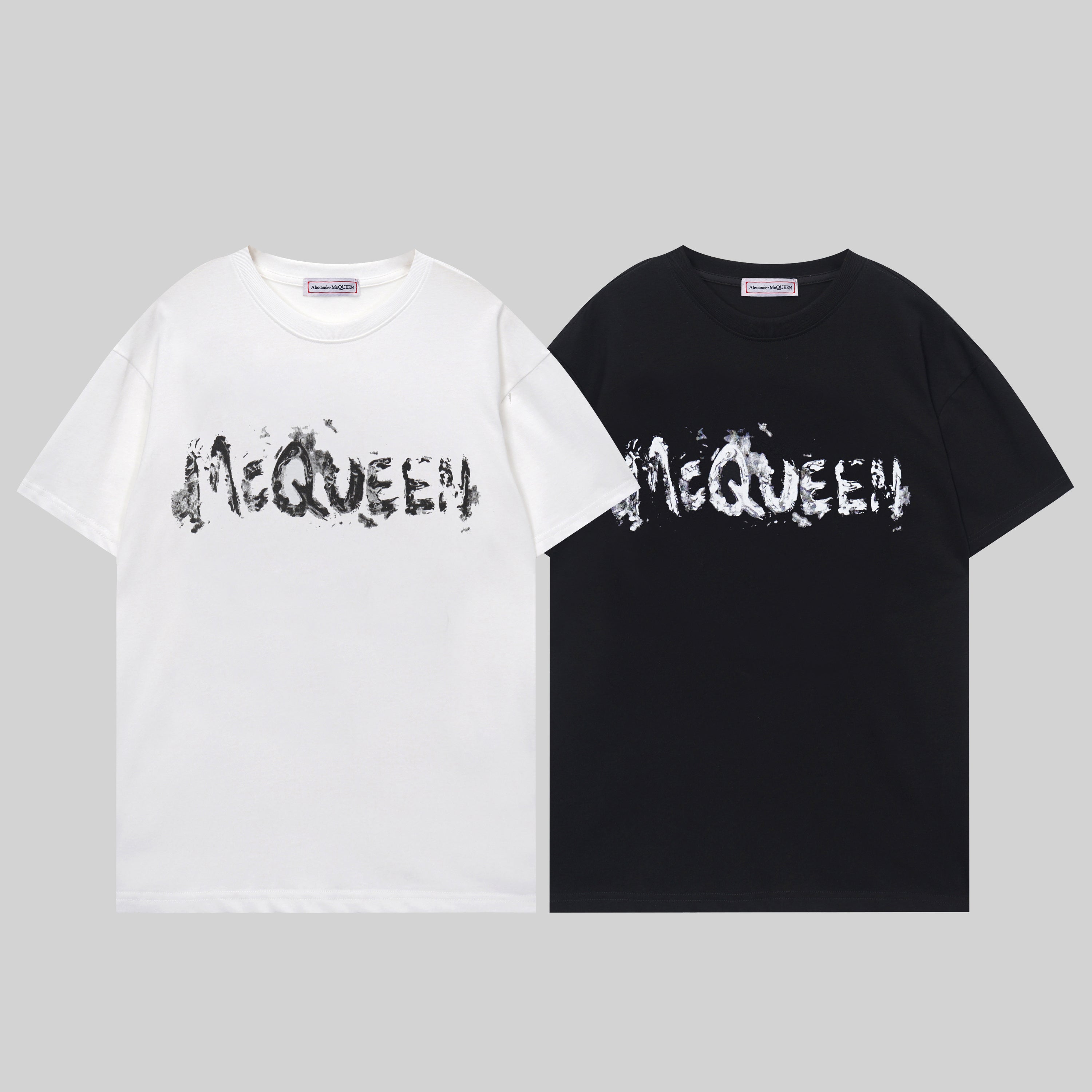 Black and white crewneck T-shirts with McQUEEN graffiti-style lettering