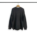 Dark crewneck sweatshirt with long sleeves and ribbed cuffs and hem