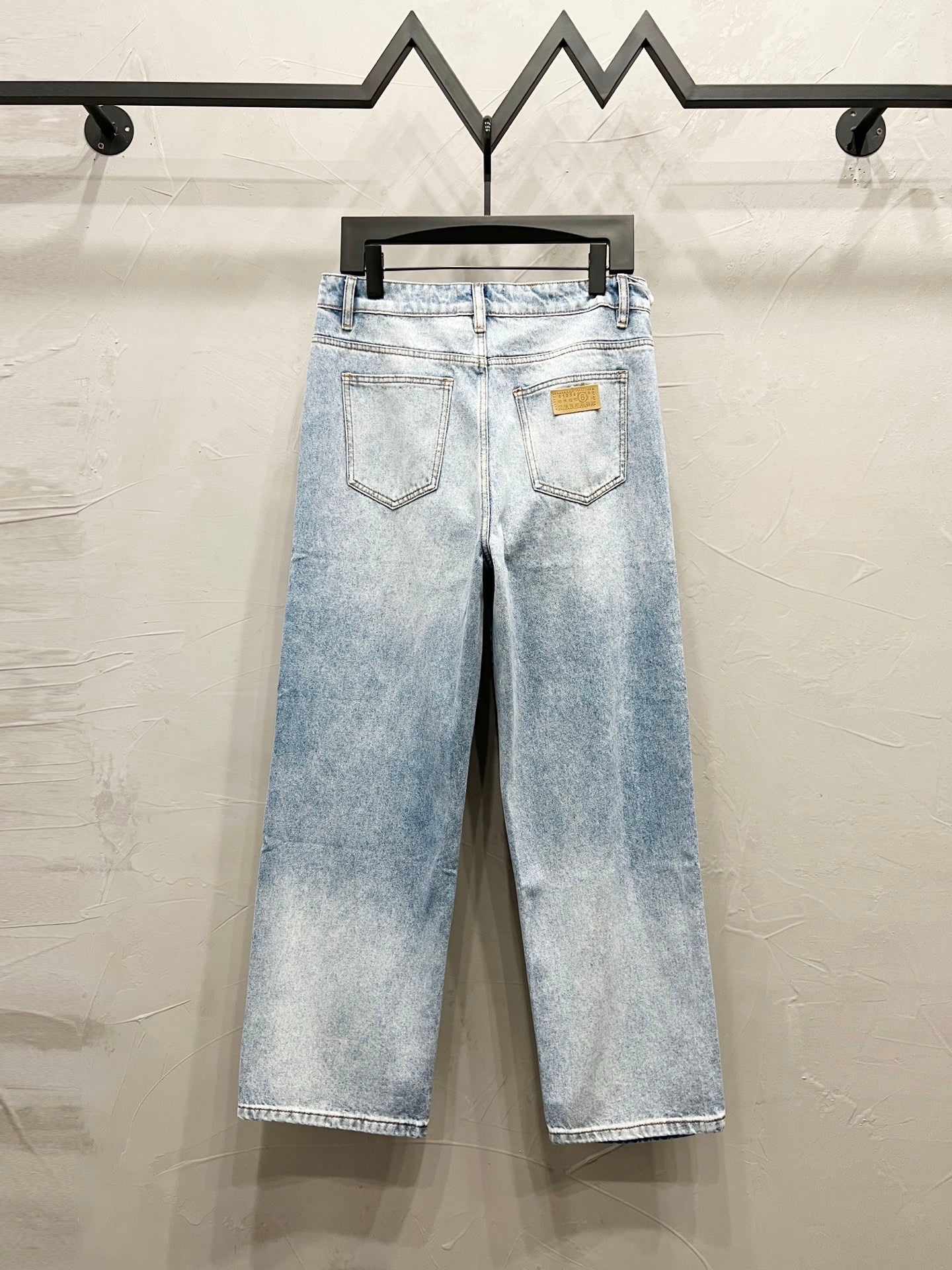Maison Margiela denim jeans, light wash with back pockets and logo patch on waistband