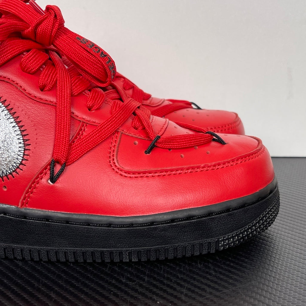 Red leather low-top sneakers, black sole edge, silver swoosh and lace panel