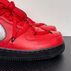 Red leather low-top sneakers, black sole edge, silver swoosh and lace panel
