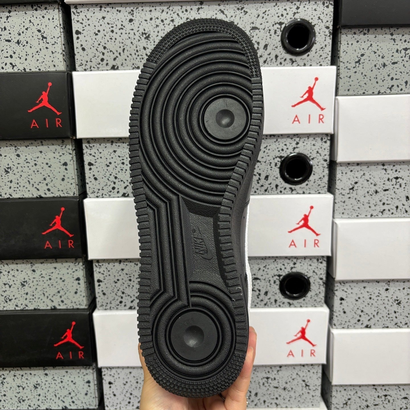Black sneaker outsole with circular traction tread pattern