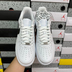 White low-top sneakers with lace-up front and Air branding on tongue, front view