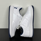 White Nike Air Force 1 pair with navy heel tab and blue-striped outsole