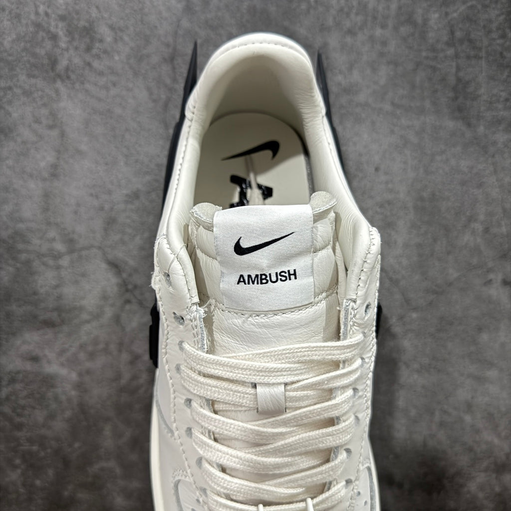 White sneaker heel with Nike logo and stitched AMBUSH label on strap
