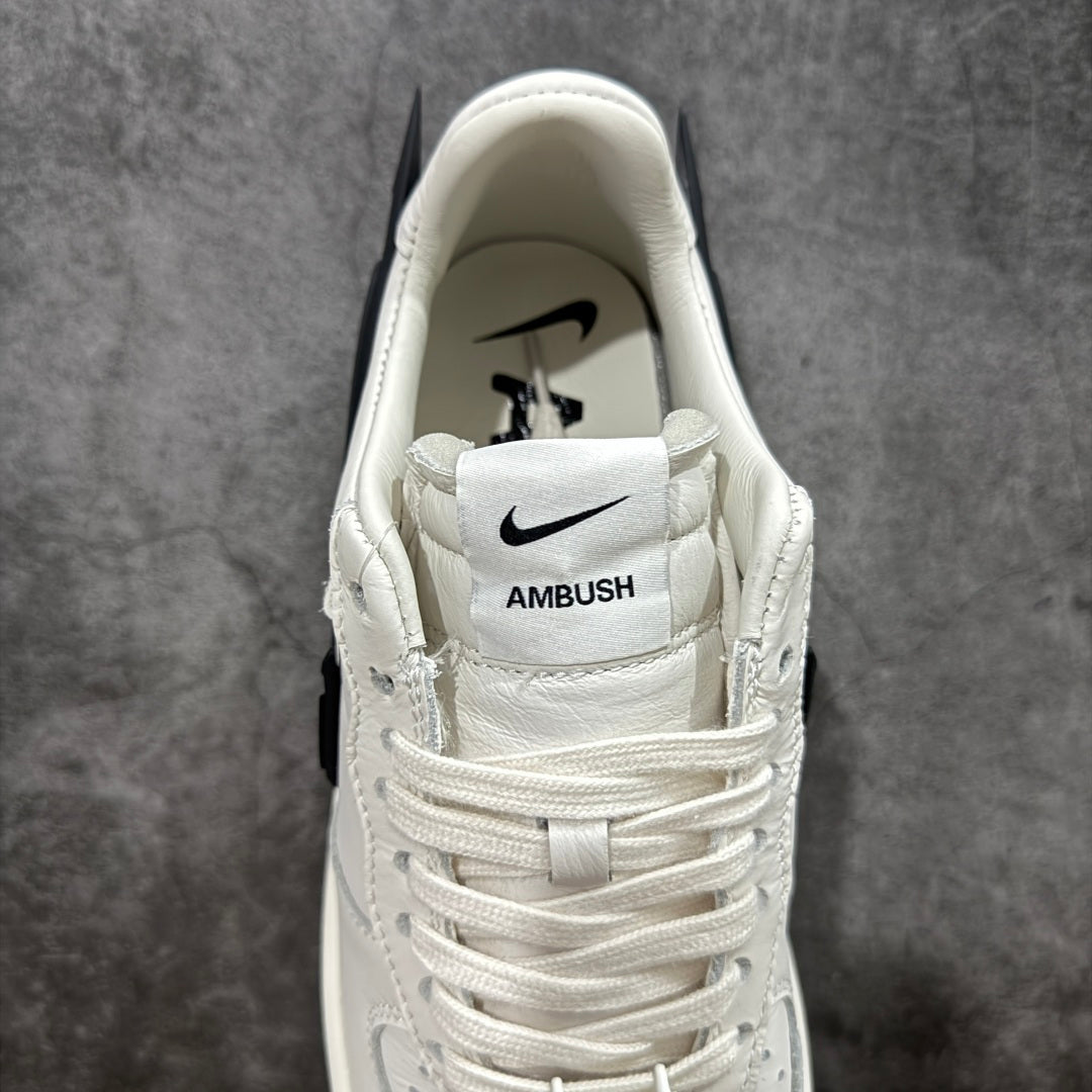 White sneaker heel with Nike logo and stitched AMBUSH label on strap
