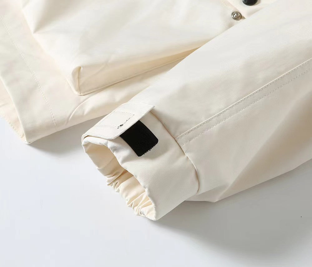 White jacket sleeve cuff with elastic gather and buttoned cuff end