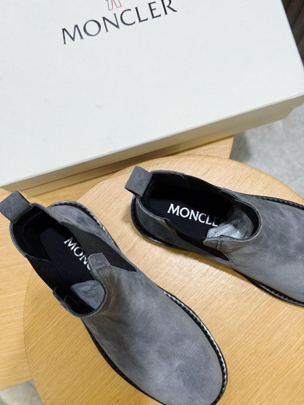 Moncler suede Chelsea boots showing interior lining and brand on the insole