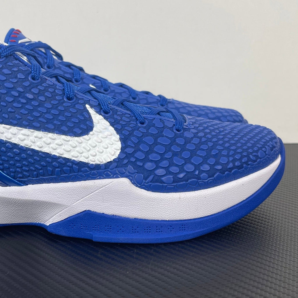 Blue Nike basketball sneaker side view with textured upper and white swoosh
