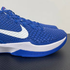 Blue Nike basketball sneaker side view with textured upper and white swoosh