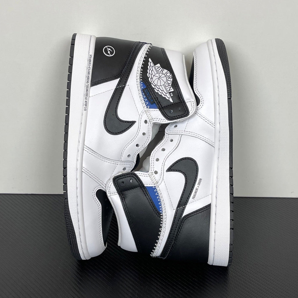Back/side view of white and black high-top sneakers with black heel tabs and blue trim