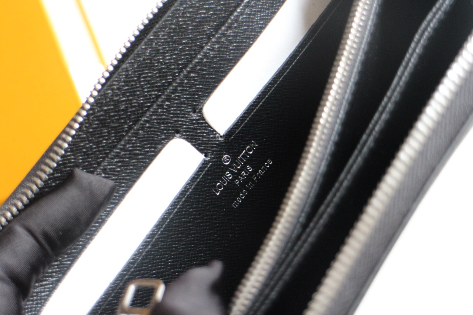 Louis Vuitton small black leather bag interior detail with card slots and logo