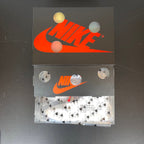 Nike shoebox with orange swoosh logo and patterned wrapping paper