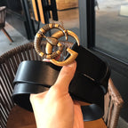 Black leather belt with gold-tone ornate buckle and straight strap