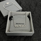 Silver Balenciaga logo pendant necklace shown in a gray box