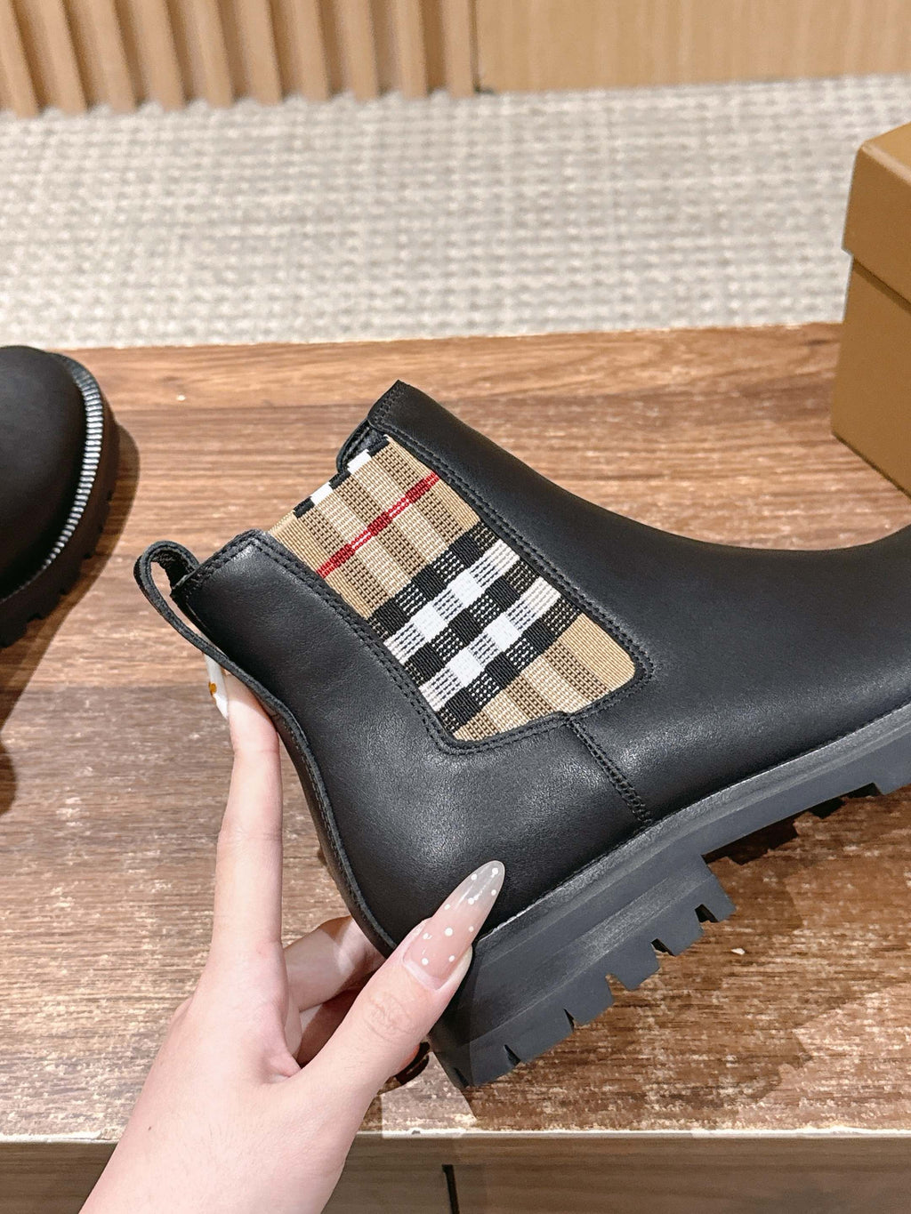 Black leather Chelsea boot with check elastic side panel and treaded rubber sole