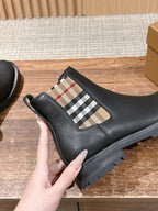 Black leather Chelsea boot with check elastic side panel and treaded rubber sole