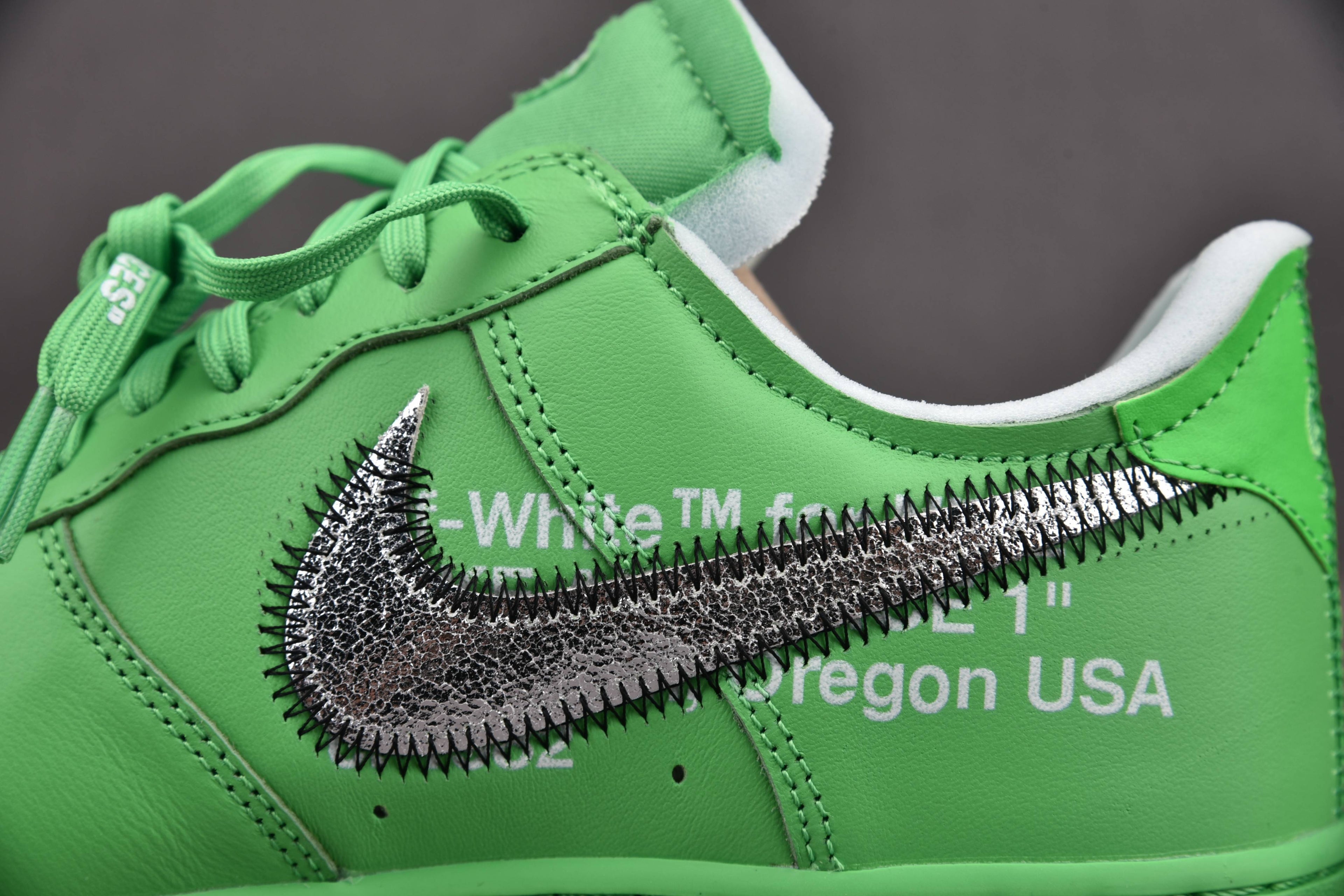 Green low-top sneakers with metallic swoosh detail and white midsole edge