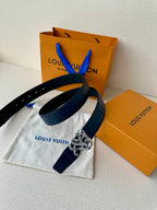 Louis Vuitton belt: dark blue embossed leather with silver-tone knot buckle